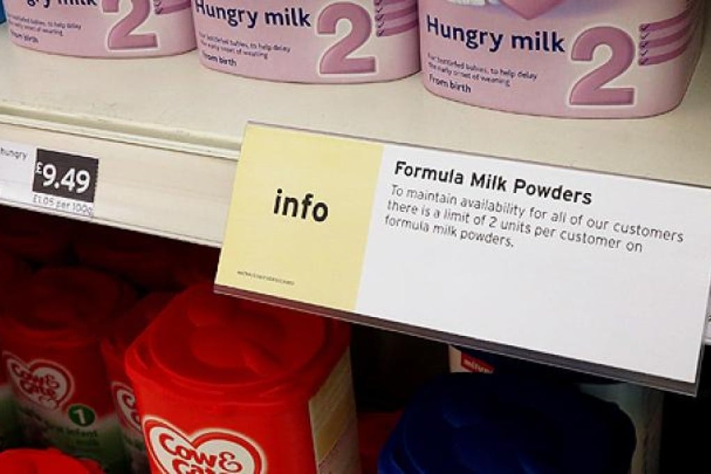 A sign limiting the purchase of baby milk formula powder hangs on the shelf in a supermarket in London, on Wednesday. Photo: AP