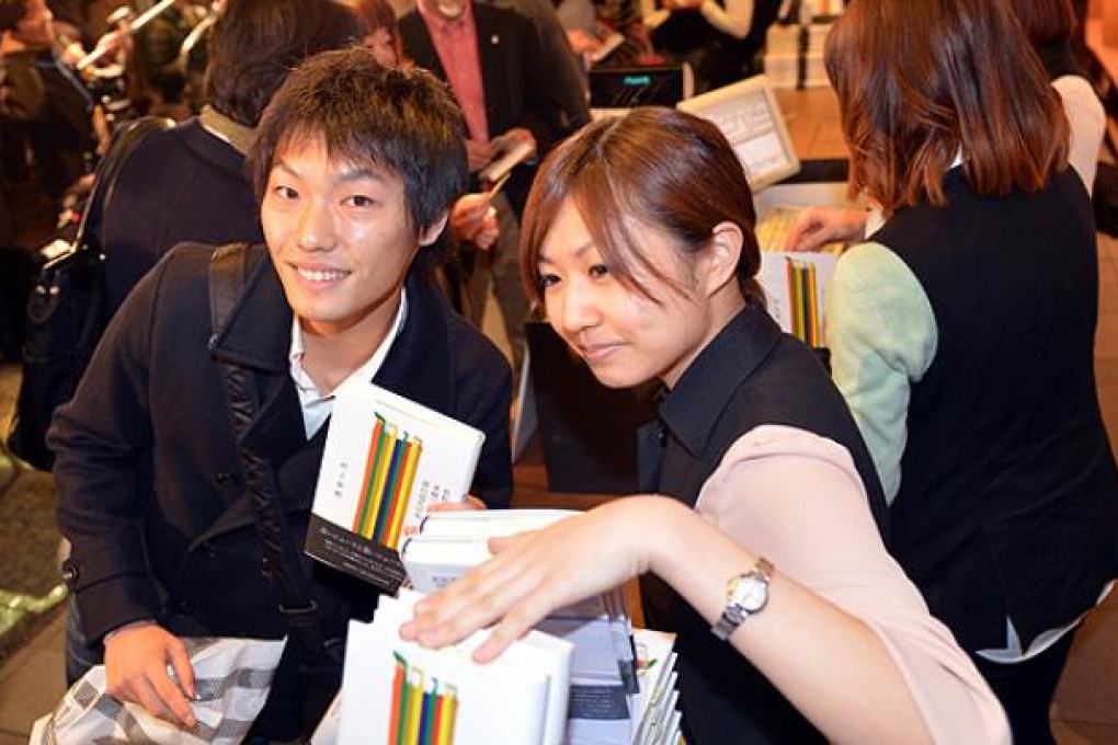 Fans of Japanese author Haruki Murakami buy his newly published book at the Tsutaya book store in Tokyo. Photo: AFP