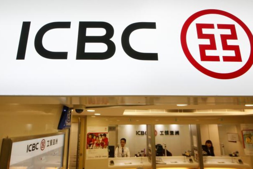Bank tellers sit in a branch office of the Industrial and Commercial Bank of China (ICBC) in Hong Kong. Photo: AP