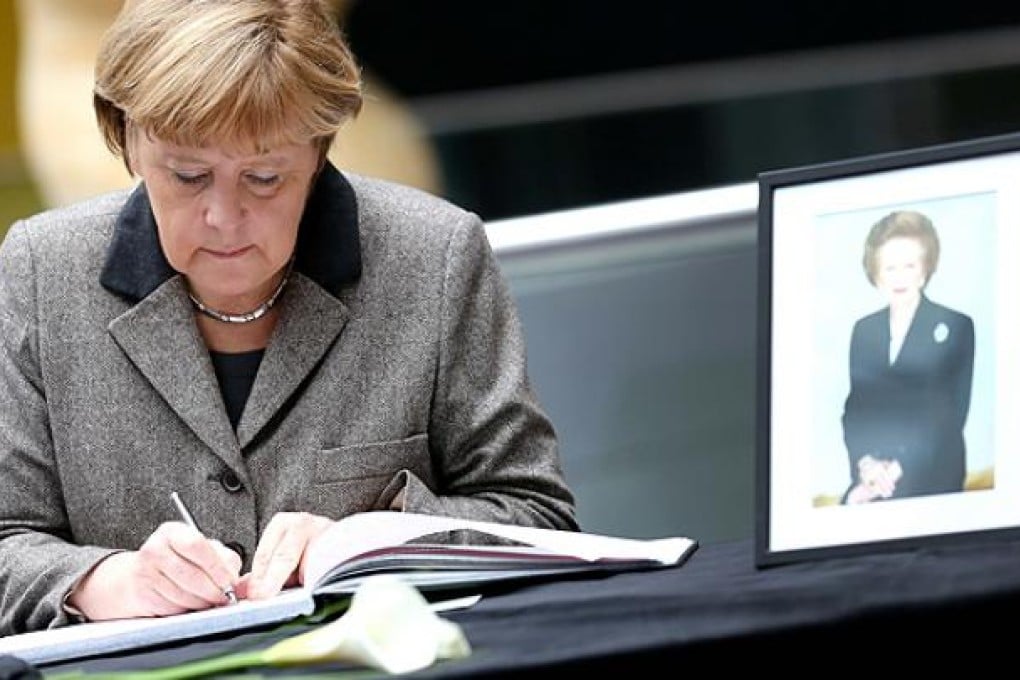 German Chancellor Angela Merkel signs a book of condolence in memory of former British Prime Minister Margaret Thatcher. Photo: AP