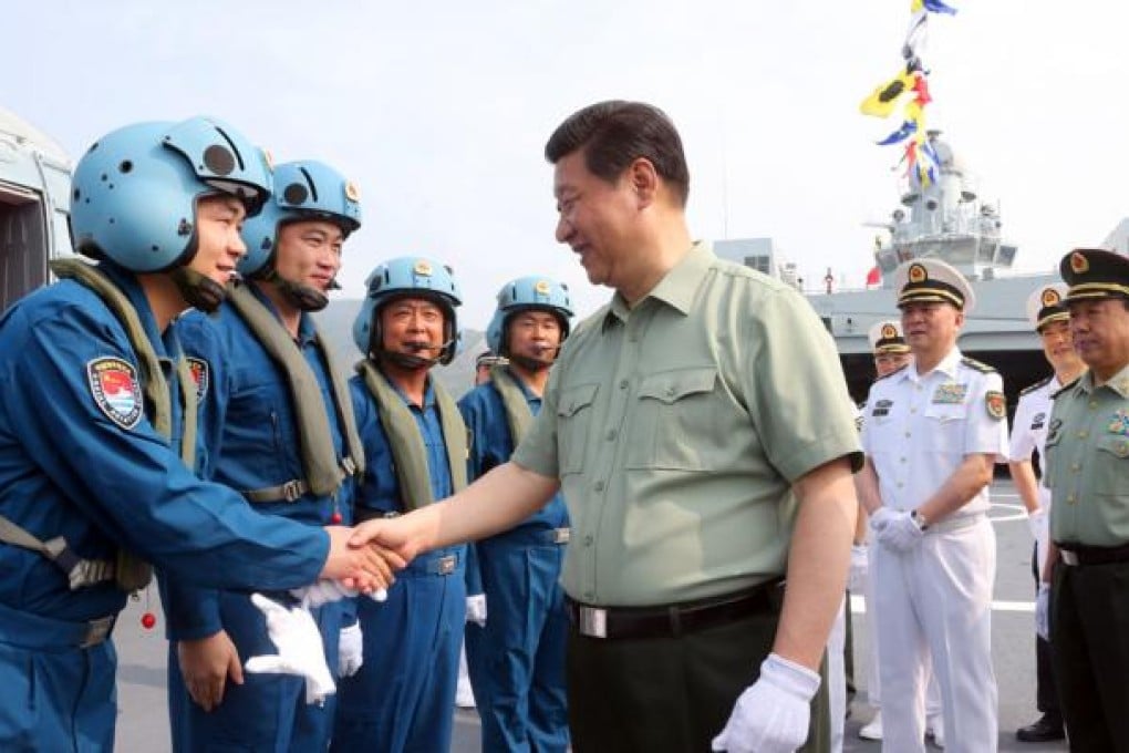 President Xi Jinping shakes hands with helicopter pilots in Sanya, Hainan province. Photo: Xinhua