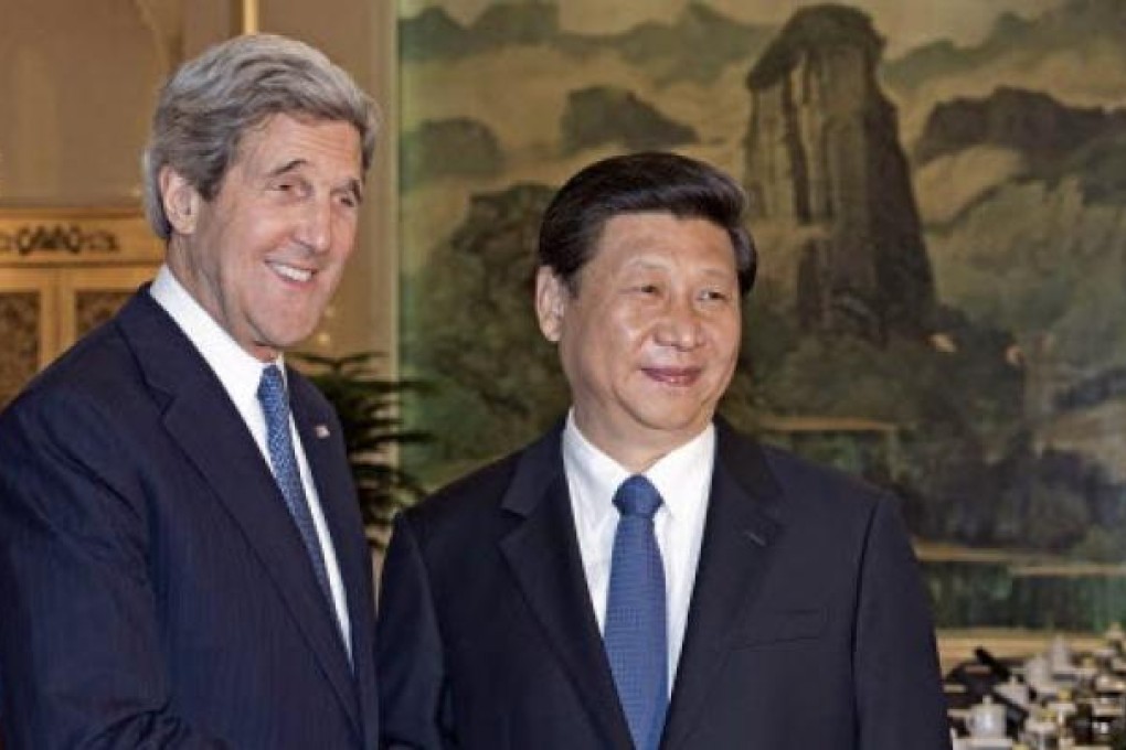 US Secretary of State John Kerry, left, is greeted by Chinese President Xi Jinping on Saturday. Photo: AP