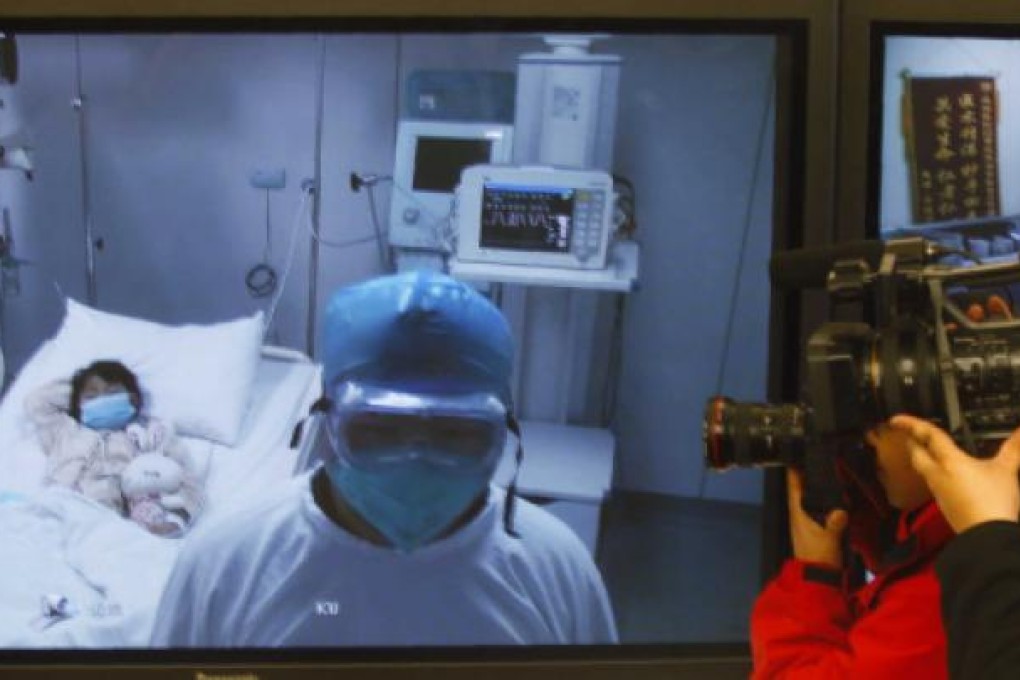 Journalists take pictures and videos of a screen showing the seven-year-old girl officials at Ditan Hospital confirmed as suffering from the H7N9 bird flu strain. Photo: Reuters
