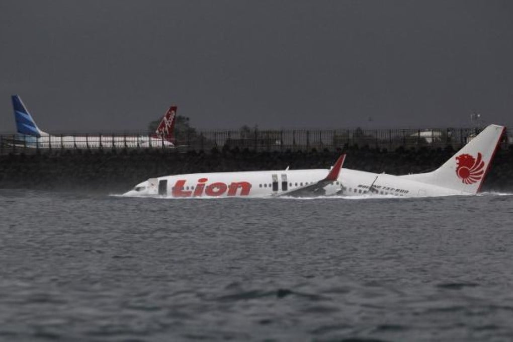 The broken body of the Lion Air plane lies on the water after missing the runway in Bali. Photo: Reuters