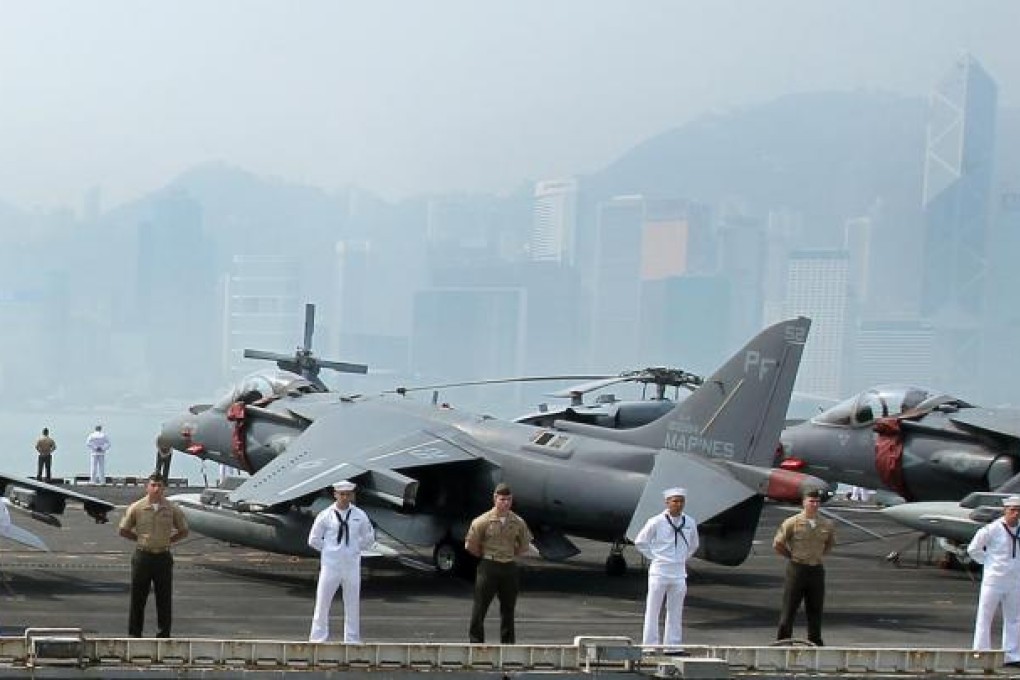 American sailors and marines stand on the deck of the amphibious assault vessel USS Peleliu, which has tied up In Victoria harbour with the landing vessels USS Rushmore and USS Green Bay. Photo: Dickson Lee