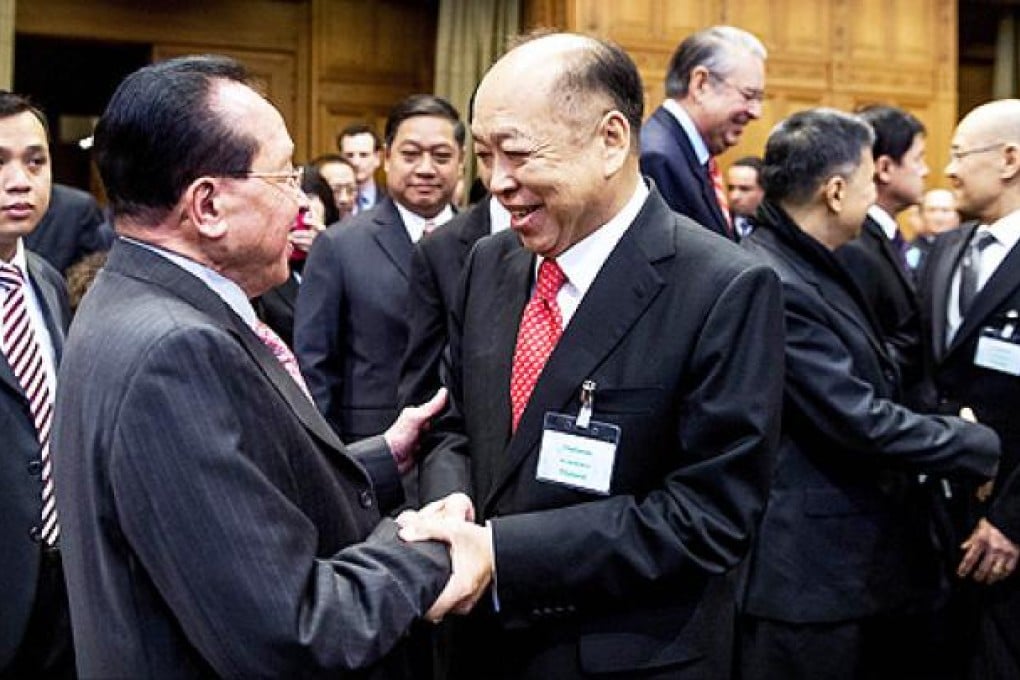 Thailand's Deputy Prime Minister and Foreign Affairs minister Surapong Tovichakchaikul (right) shakes hands with his Cambodian counterpart Hor Namhong during a hearing at the UN's highest court on Monday. Photo:  AFP