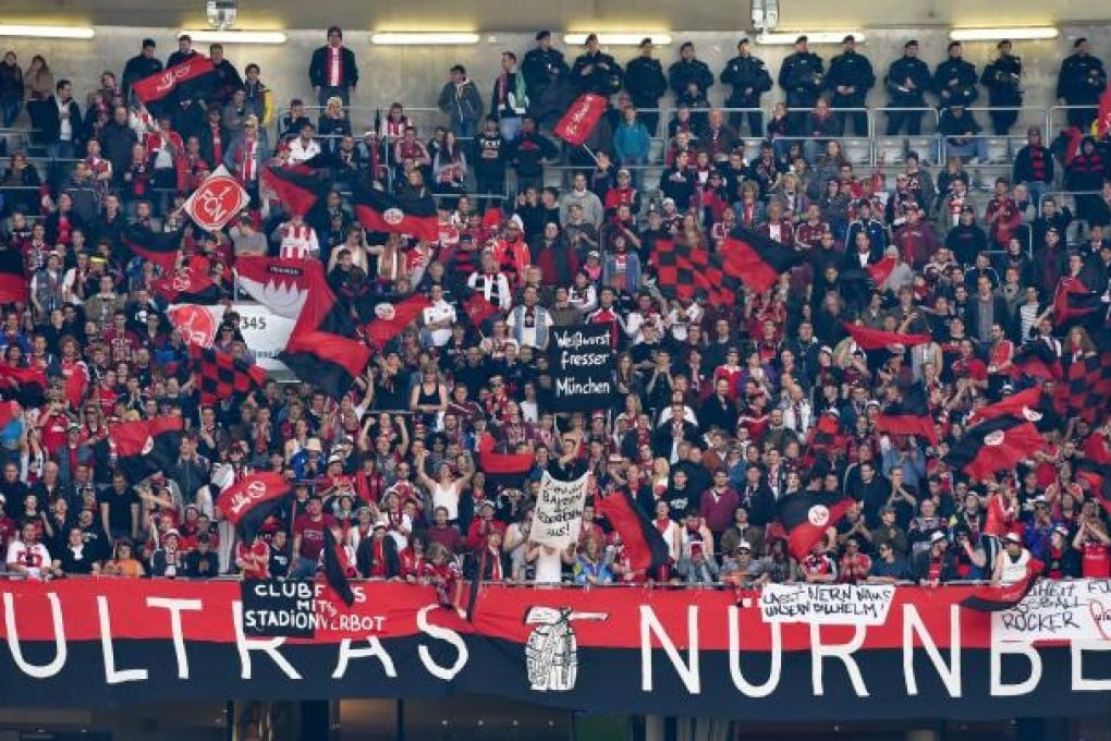 Nuremberg fans during the match in Munich - fierce clashes with Bayern supporters before kick-off led to 61 arrests. Photo: AFP
