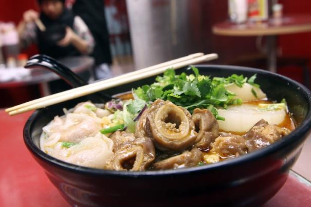 Rice vermicelli with soup and white radish, pig intestine and fish dumplings. Photo: Jonathan Wong