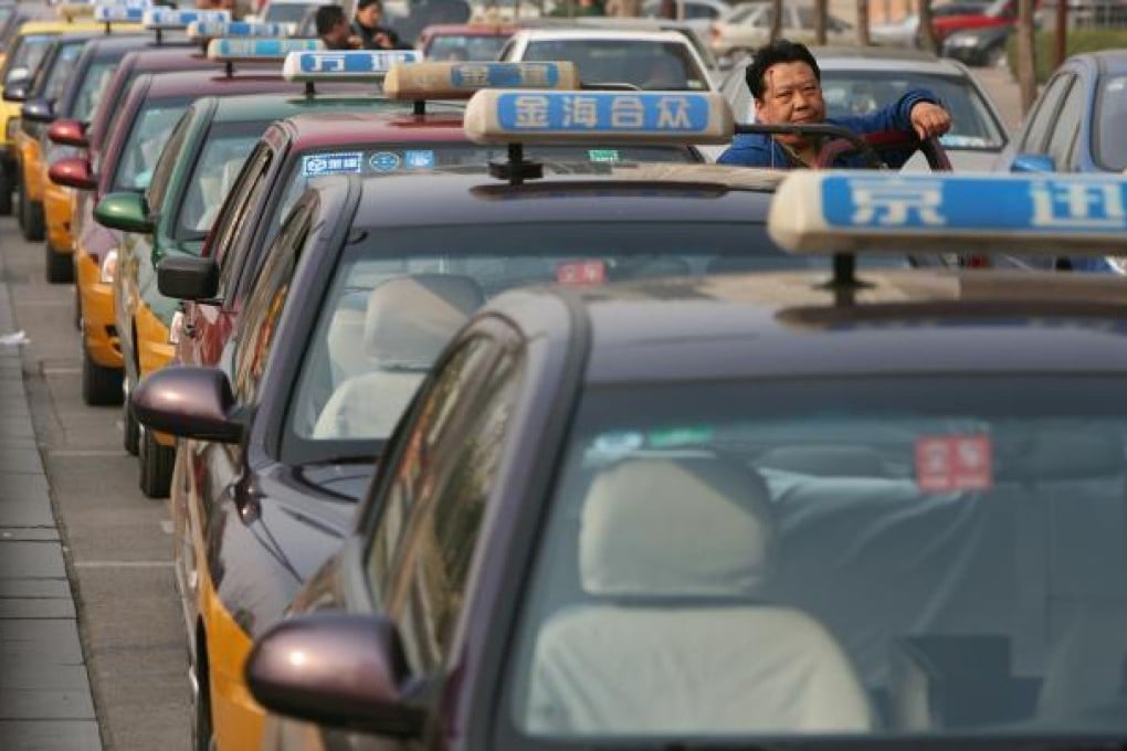 Taxi drivers queue up at a taxi stand at a shopping area in Beijing. Photo: SCMP