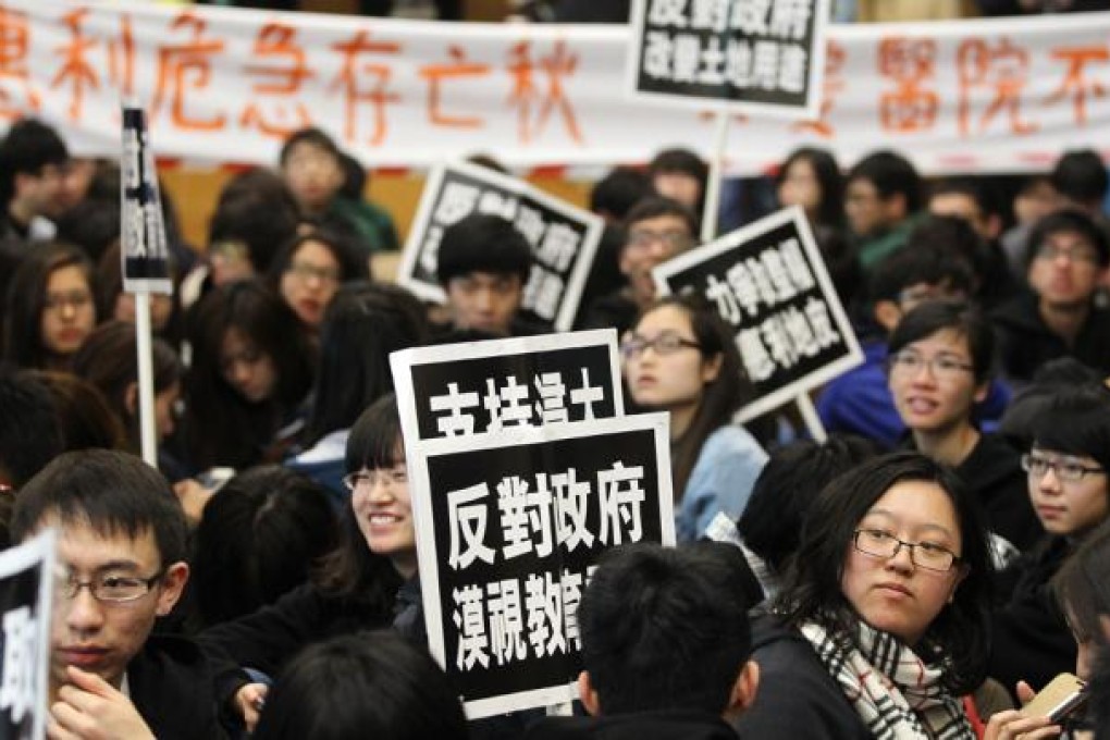 Students of Hong Kong Baptist University protest at North Point Government Building during Town Planning Board's meeting on the land usage on former Lee Wai Lee Technical Institute. Photo: Edward Wong