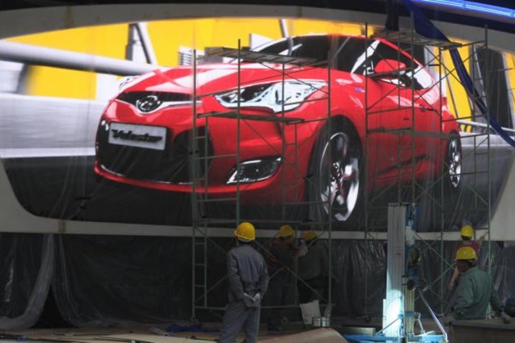 Workers building the Hyundai stand at the Shanghai car show. Figures show 6.48 million Chinese-brand cars were sold last year. Photo: AFP