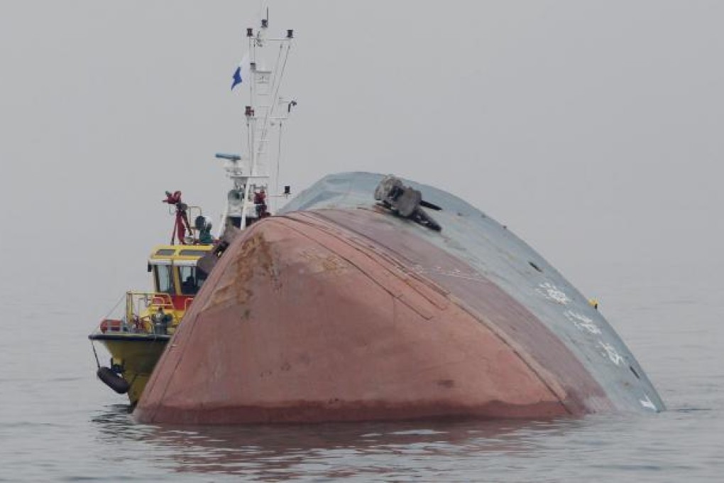 Divers continue to search the sunken barge for the missing men but poor visibility and debris are hampering efforts. Photo: Felix Wong