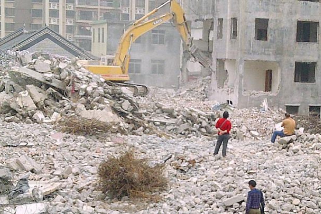 Most of Tan village is buried under concrete rubble. There is no telephone line, internet access or street lights. Photo: Mimi Lau