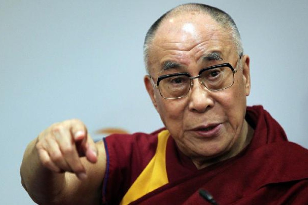The Dalai Lama gestures during a press conference in Londonderry, Northern Ireland, on April 18, 2013. Photo: AFP