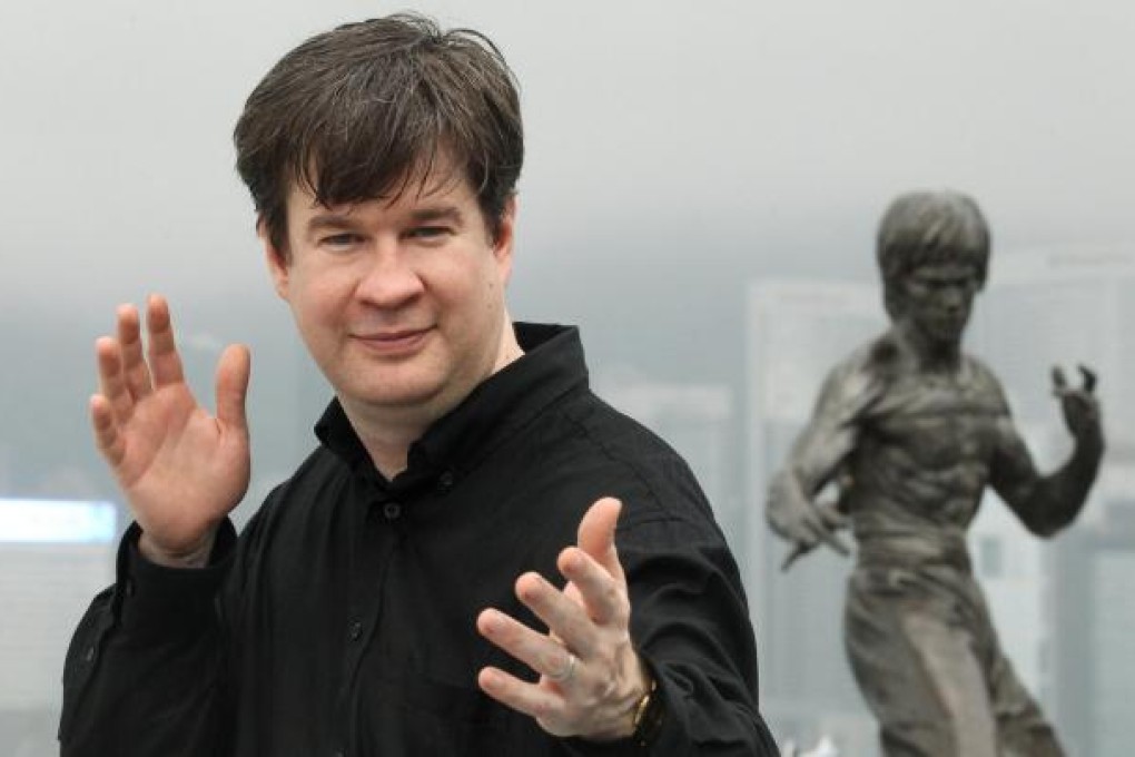 Martial arts expert Matthew Polly in front of a statue of Bruce Lee in Tsim Sha Tsui. Polly, who dropped out of Princeton to become a Shaolin apprentice, is writing the late star's biography. Photo: Edward Wong