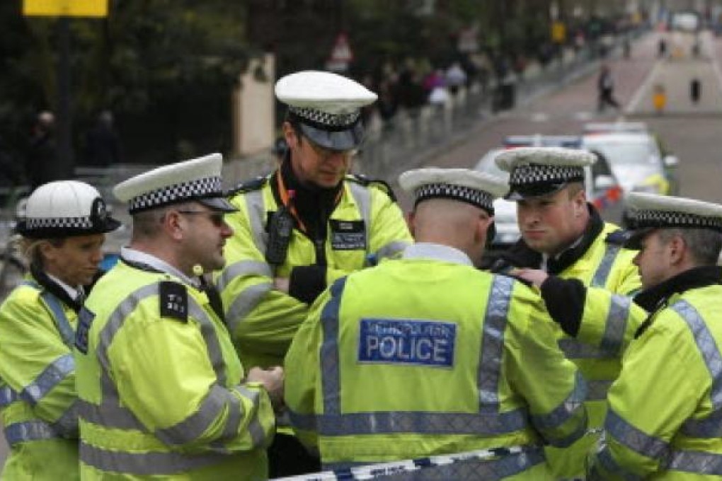 British police officers gather near the Mall in central London. > Britain is increasing police numbers by 40 per cent for Sunday’s London marathon. Photo: AP