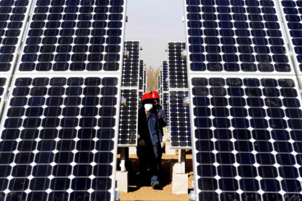 Workers check solar panels in Yulin, in Shaanxi province. China's solar-panel-making sector is the largest in the world by capacity. Photo: AP