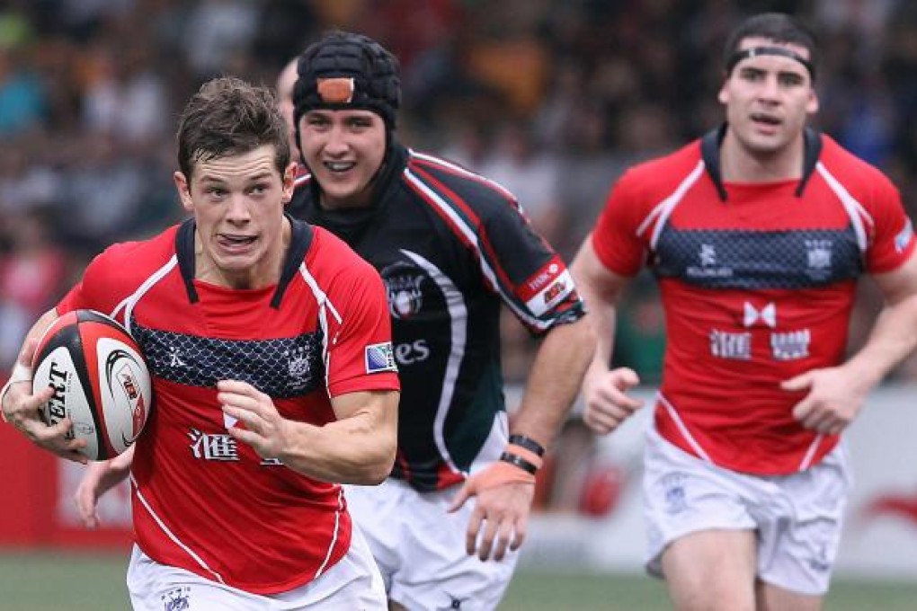 Hong Kong winger Jonny Rees surges past UAE defenders to score a try in his team's eight-try victory over the visitors. Photo: Jonathan Wong