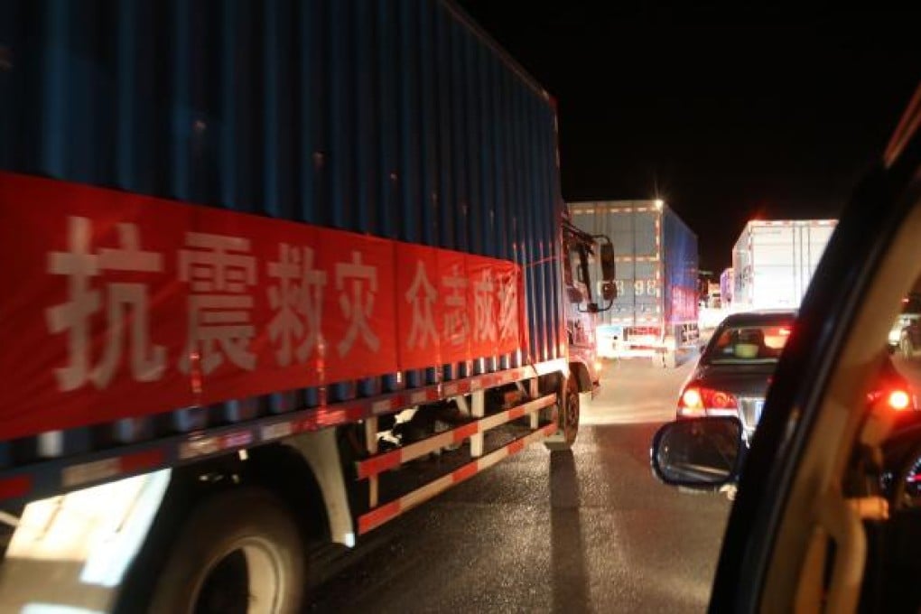 Trucks carrying relief supplies move on a road from Chengdu to the quake-hit Lushan County. Photo: Xinhua