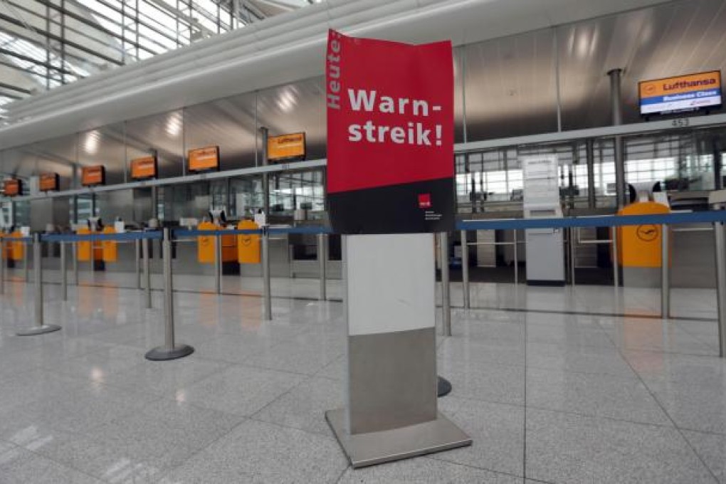 An empty terminal with a sign reading "Warning - Strike" at Munich airport during the action that grounded Lufthansa flights. Photo: AP