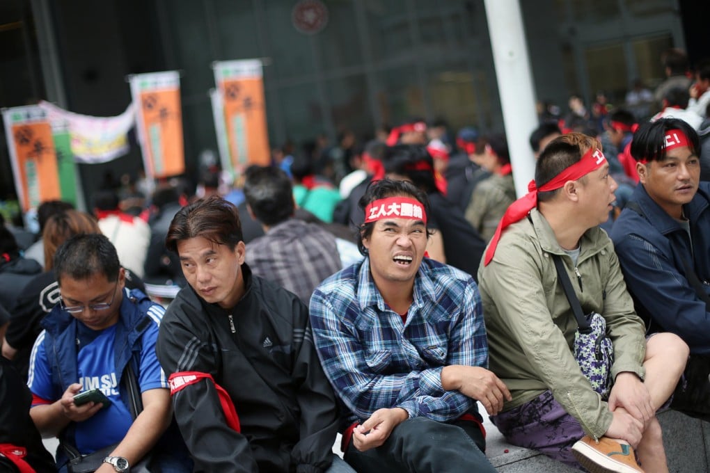 Striking dock workers at Tamar government headquarters where they met Labour Secretary Matthew Cheung. Photo: Sam Tsang