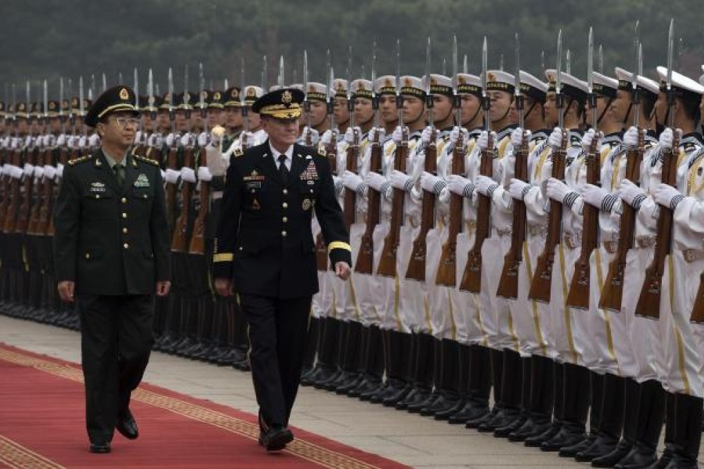 PLA General Fang Fenghui and US Joint Chiefs of Staff chairman General Martin Dempsey inspect a guard of honour in Beijing. Photo: AFP