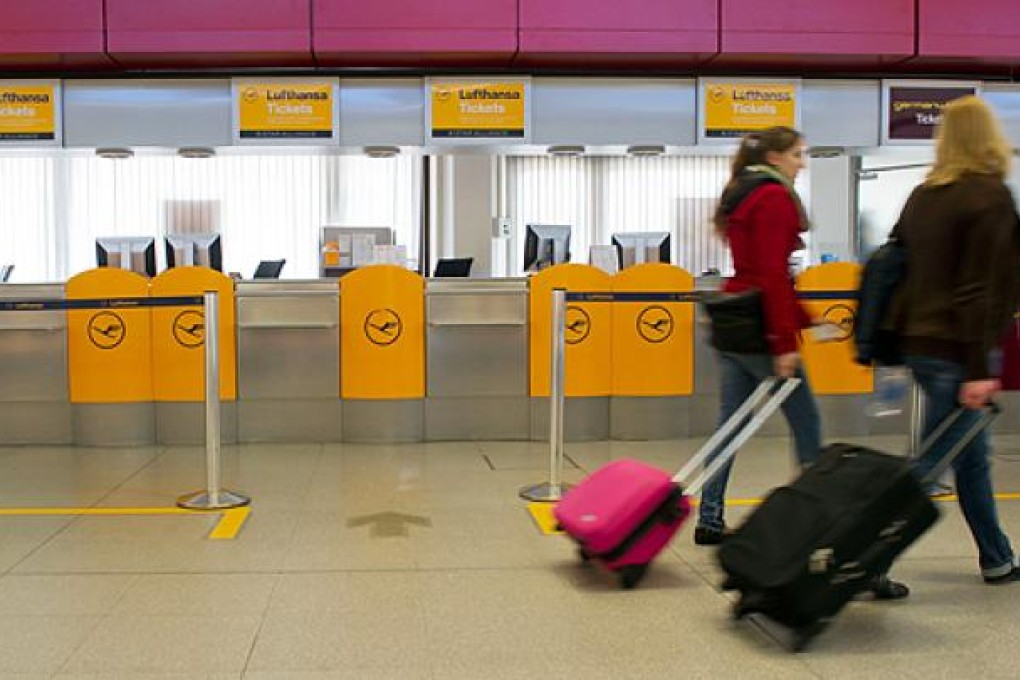 Passengers walk past empty check in desks at the Berlin Tegel airport on Monday after German airline Lufthansa cancelled most of its domestic, European and long-haul flights at six German airports due to strike action by ground personnel and some cabin crew. Photo: AFP