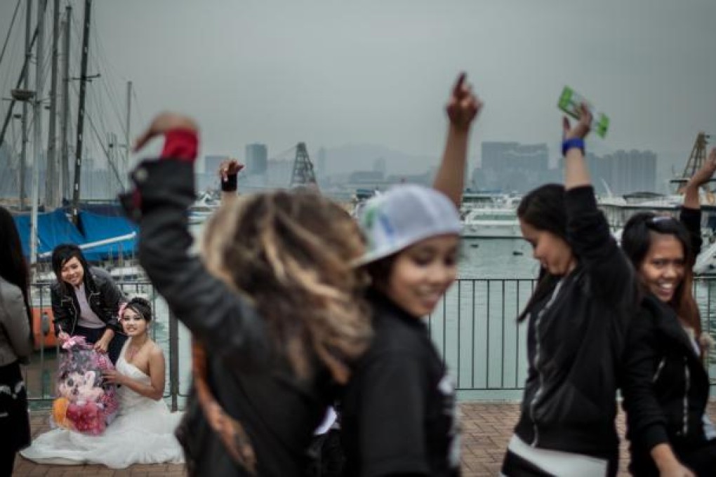 Abellya (in white) and Yoean pose for their "wedding" pictures with dolls, their symbolic children, in January last year.