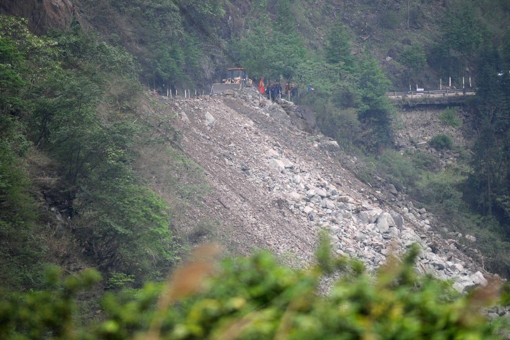 Rescuers work to clear the debris after landslides on the Guanyan Mountain section of the S210 highway in quake-hit Baoxing county, Sichuan province. Photo: Xinhua