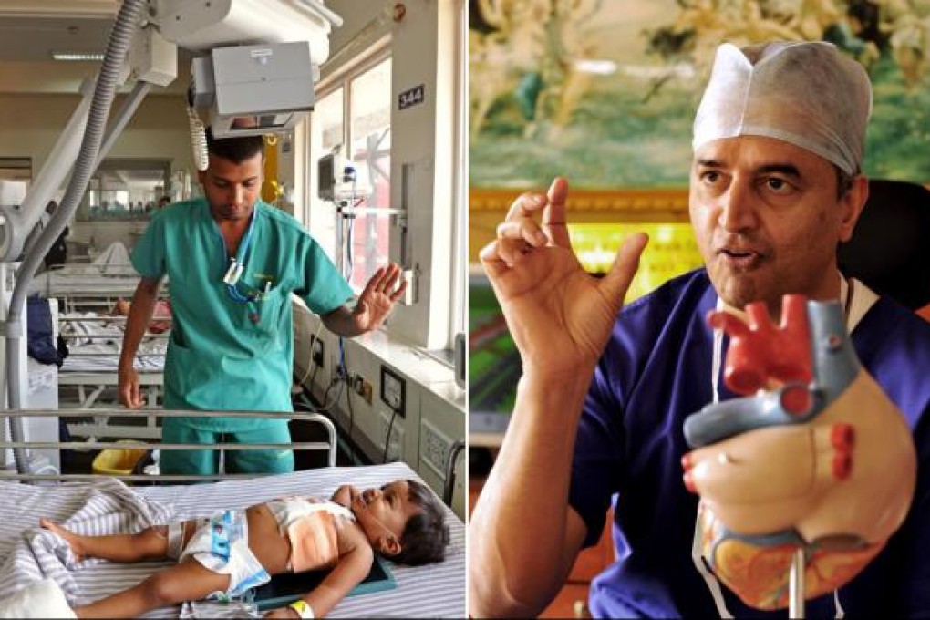 A staff member at Narayana Hrudayalaya clinic attends to an infant while founder and surgeon Devi Shetty explains a point. Photos: AFP