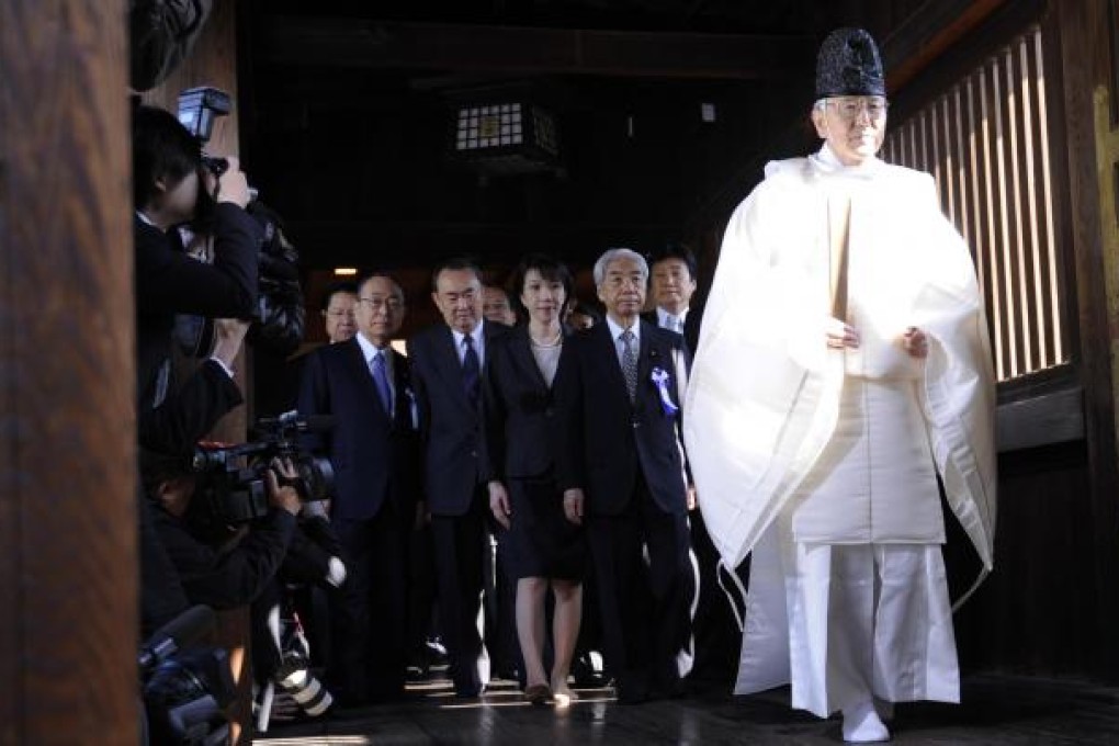 Japanese lawmakers visit the Yasukuni war shrine in Tokyo yesterday. It was the largest contingent of politicians since 2005. Photo: Xinhua