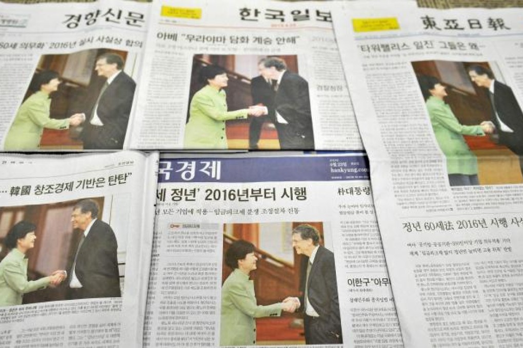 South Korean newspapers show the offending handshake. Photo: AFP