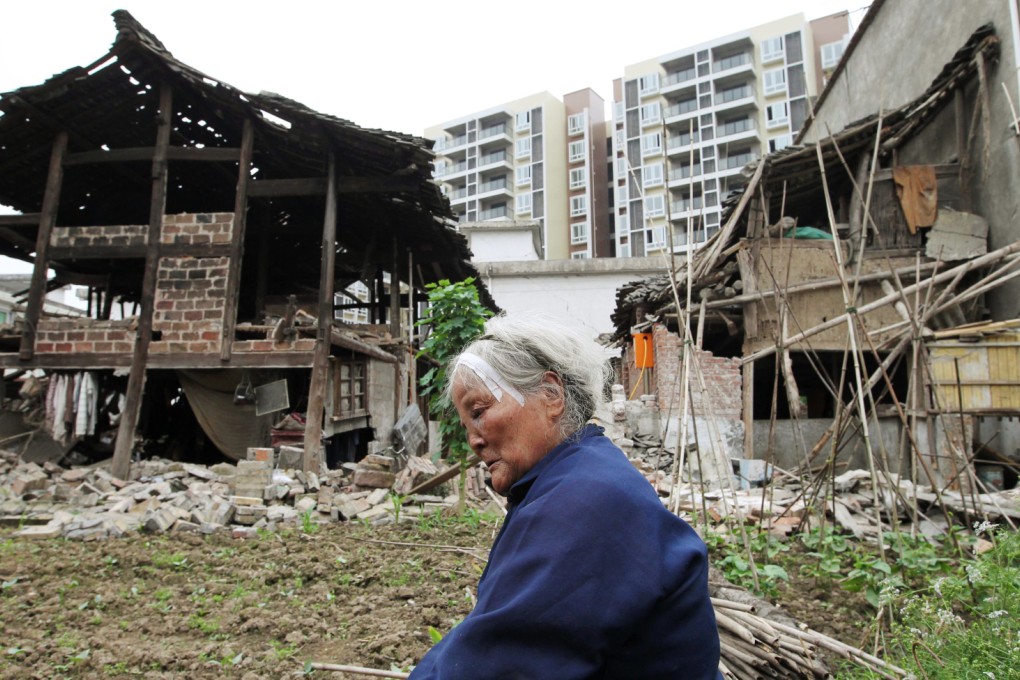 An old women sits in front her house after the earthquake at Lushan county, Ya'an city, Sichuan province. Photo: SCMP/Simon Song