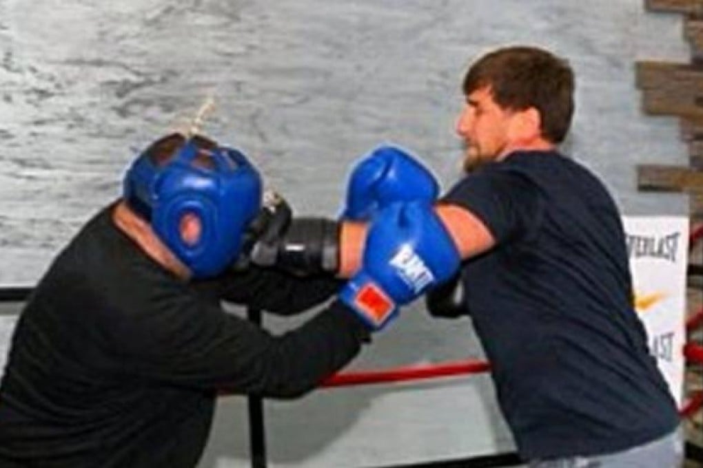 Chechnya's leader Ramzan Kadyrov (right) teaching one of his ministers a 'lesson' during a sparring session. Photo: SCMP Picture