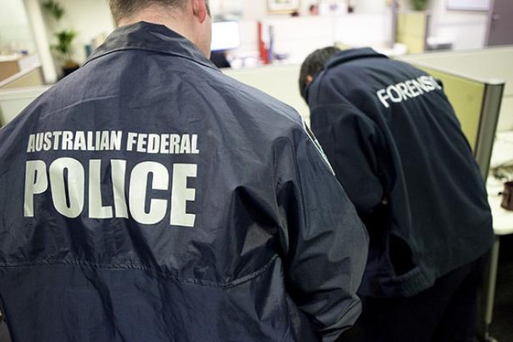 Forensics officers examining items during a search warrant following the arrest of the self-proclaimed leader of the LulzSec international hacker group at a town 75km north of Sydney.  Photo: AFP