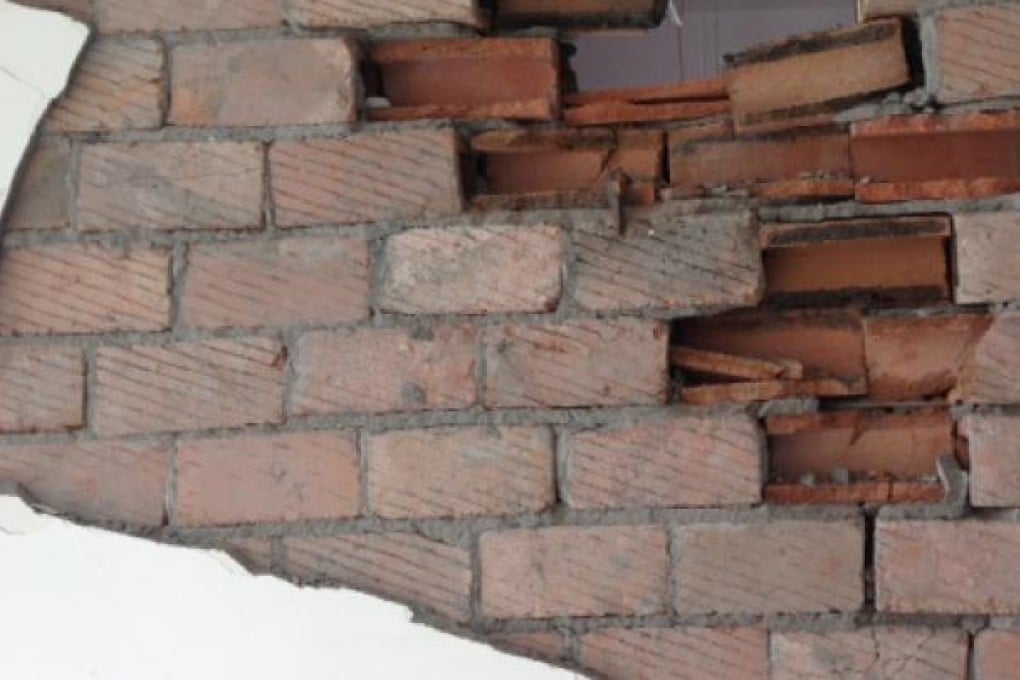 A damaged wall inside Lushan County Junior Secondary School reveals hollowed bricks. Photo: Simon Song