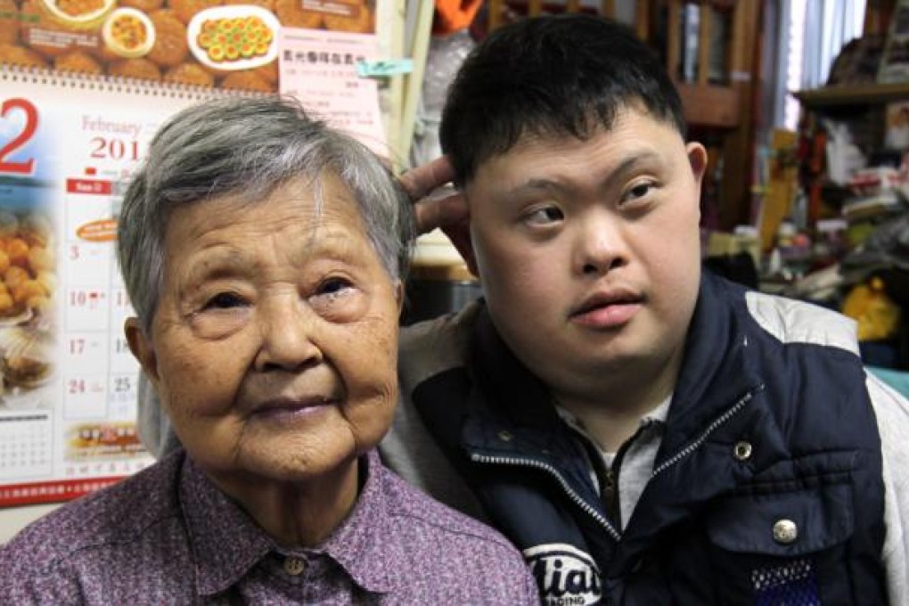 Lee Lan, 87 years old, takes care of her 45-year-old son Chan Chi-Bun, who has Down's Syndrome at Tsui Ping Estate, Kwun Tong. Photo: Dickson Lee