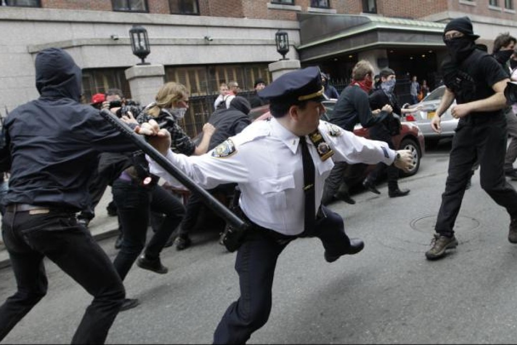 A police lieutenant swings his baton at Occupy Wall Street. Photo: AP
