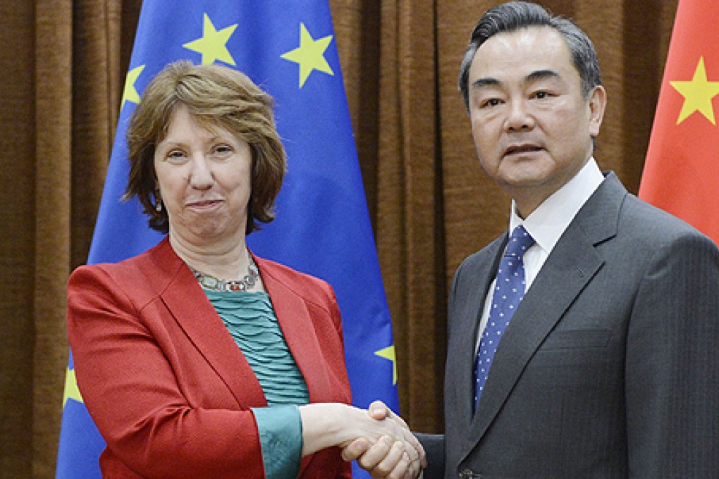 European Union foreign affairs chief Catherine Asthon (left) shakes hands with Chinese Foreign Minister Wang Yi in Beijing. Photo: AFP