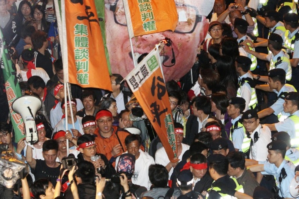 Participants in last night's unannounced demonstration are stopped by police as they mark the first month of the strike. Photo: David Wong