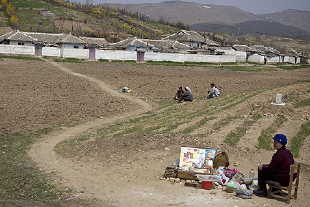 A North Korean woman sells cigarettes and snacks along a rural road near the demilitarized zone. Photo: AP