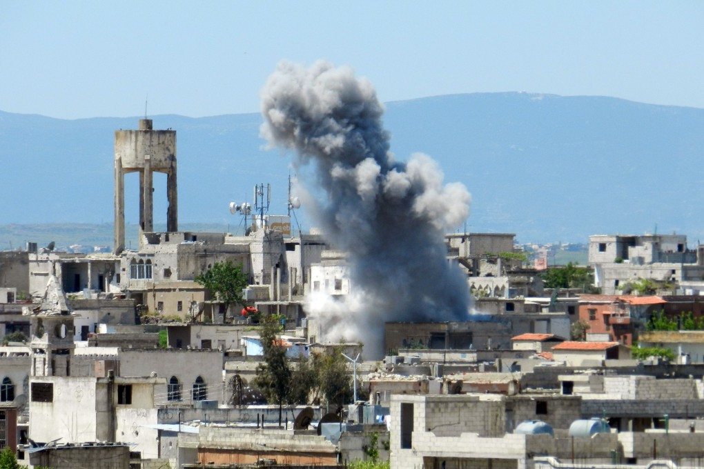 Smoke rising after heavy shelling in Houla in Syria's Homs province. Photo: AFP