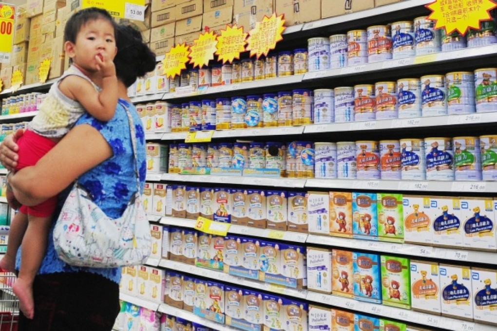 A woman selects milk powder for her child at a supermarket in Beijing. Photo: AFP