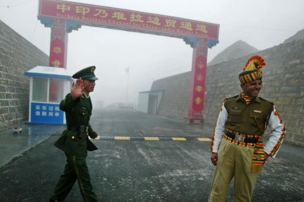 A Chinese soldier with an Indian soldier at a border crossing on the ancient Silk Road. The two sides clashed in a border war in 1962 and have since observed an undemarcated Line of Actual Control. Photo: AFP