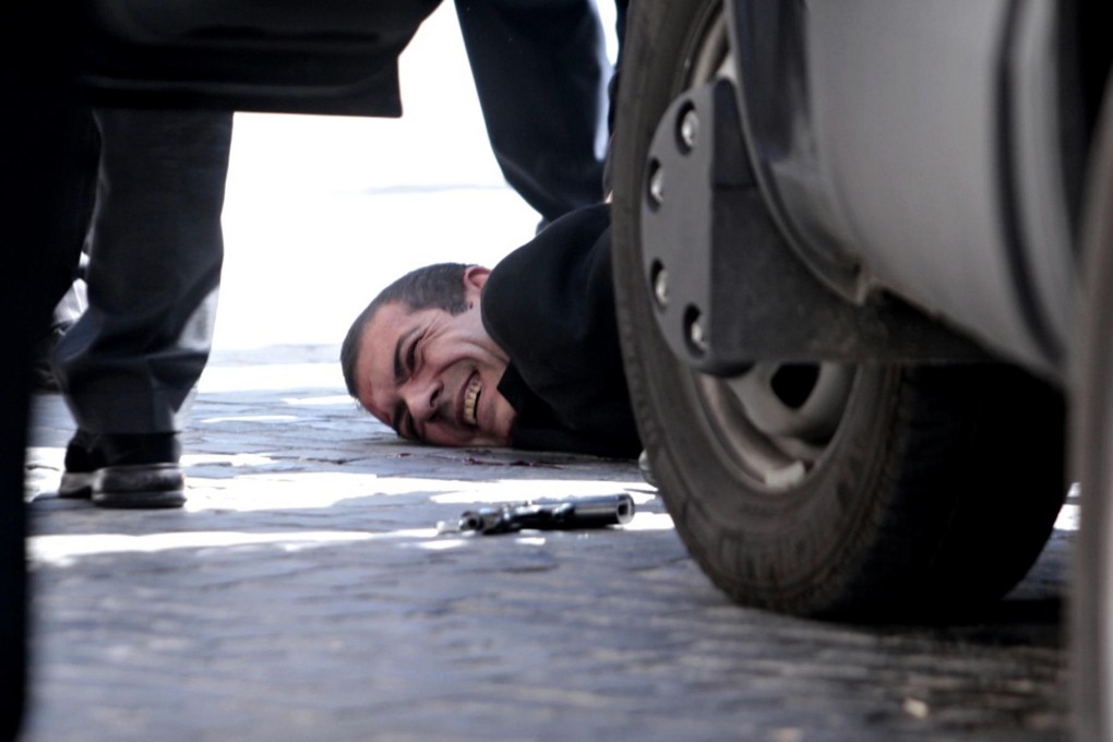 The alleged gunman is tackled to the ground. Photo: AP