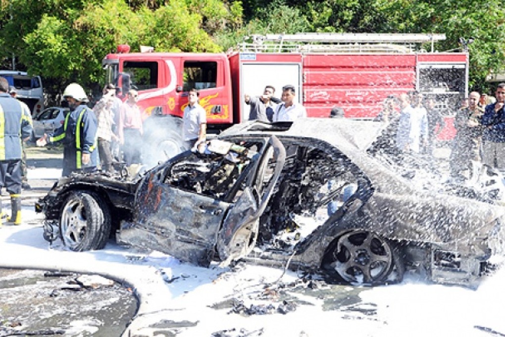 Fire fighters work at a blast site in Damascus. Syrian Prime Minister Wael al-Halqi escaped an assassination bid, surviving a blast that targeted his convoy. Photo: AFP