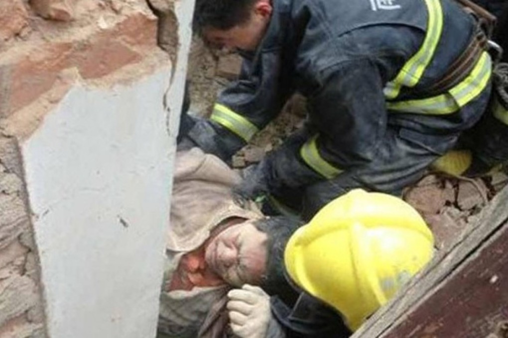 Firefighters pull an injured worker from the wreckage of the laboratory in Nanjing. Photo: SCMP Pictures