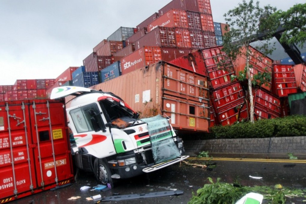 The truck driver suffered minor injuries to his face, hands and back and the left side of his vehicle was badly crushed. Photo: David Wong