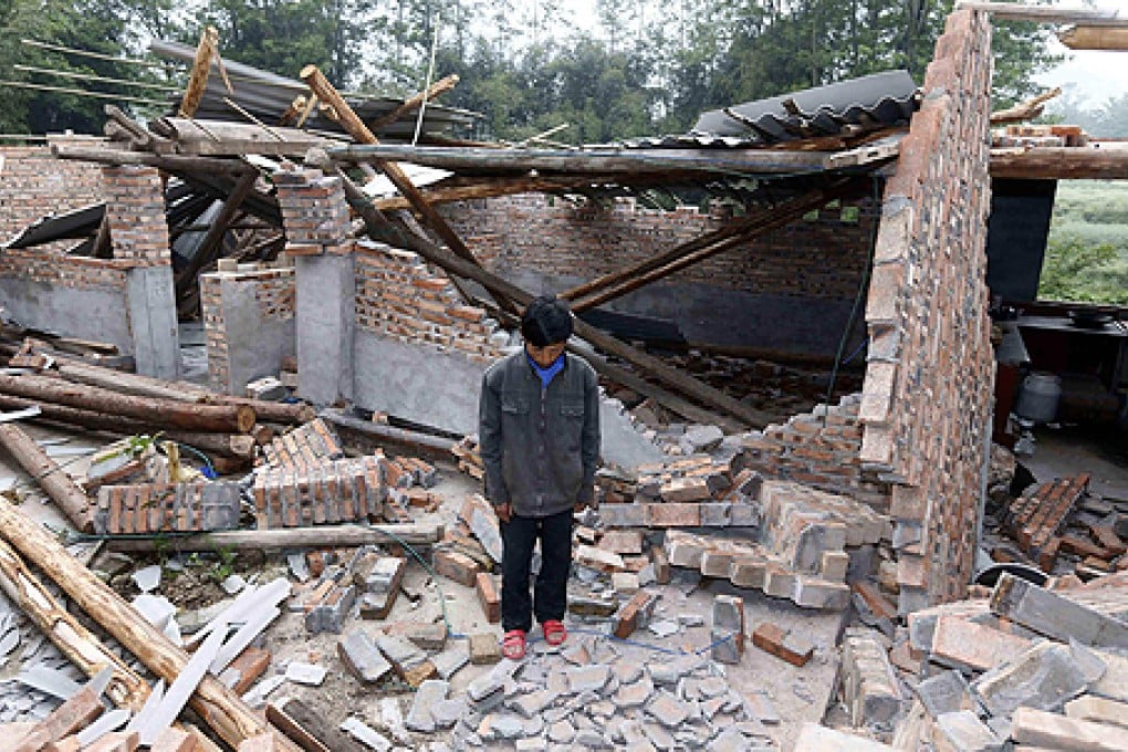 A resident stands among the Yaan quake ruins. Photo: AFP