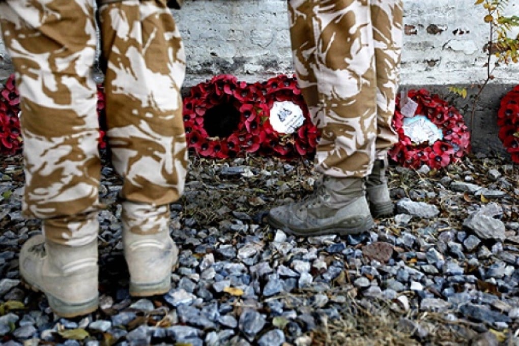 British soldiers attend a Remembrance Day ceremony at the British cemetery in Kabul. Photo: Reuters